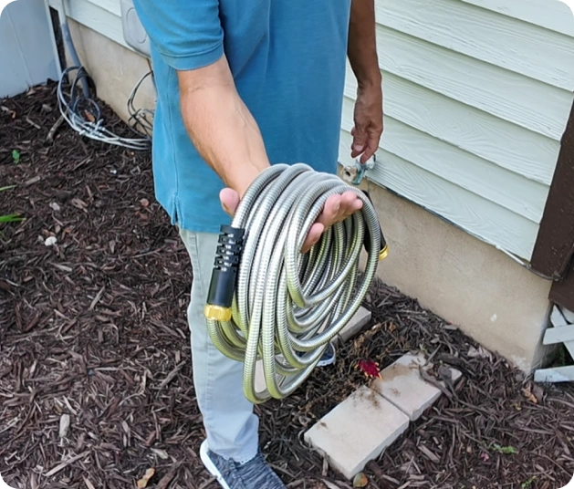Garden Maestros - Elite Metal Hose watering a U.S. lawn